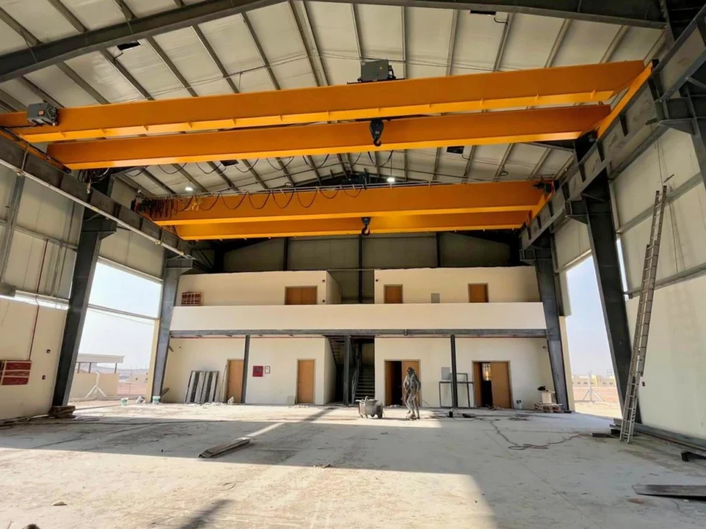 Two double girder overhead cranes installed in an industrial facility in Jordan, showcasing heavy lift cranes, overhead cranes for sale, and steel fabrication expertise.