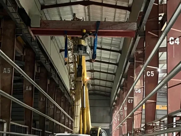 Technical team in Jordan erecting a 10-ton overhead crane during rehabilitation works, demonstrating heavy lift cranes and steel fabrication expertise.